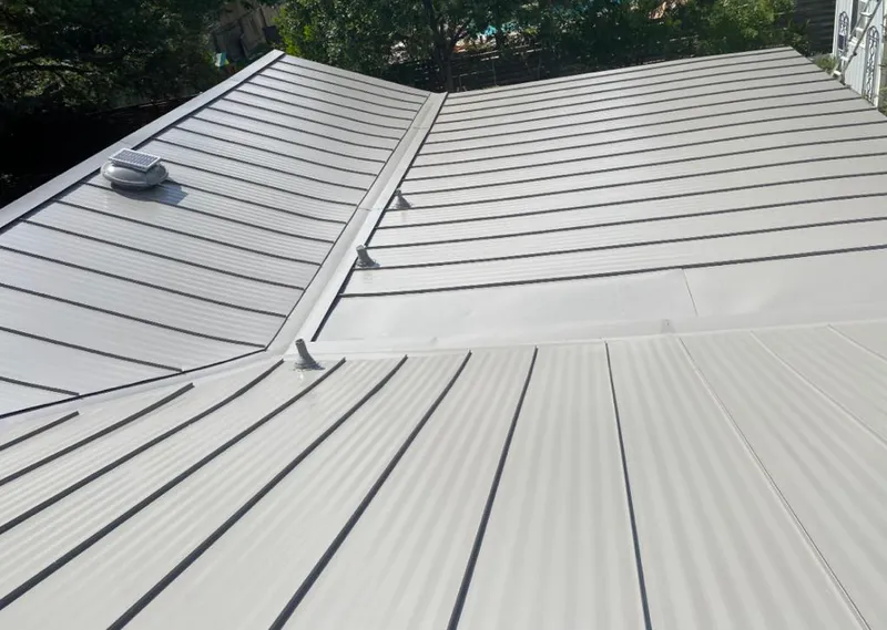Solar attic fan installed on a metal roof for Roof Ventilation in Orange